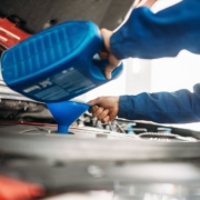 Technician change oil in the car engine. Vehicle motor maintenance, auto-service - Oil Change Nanaimo